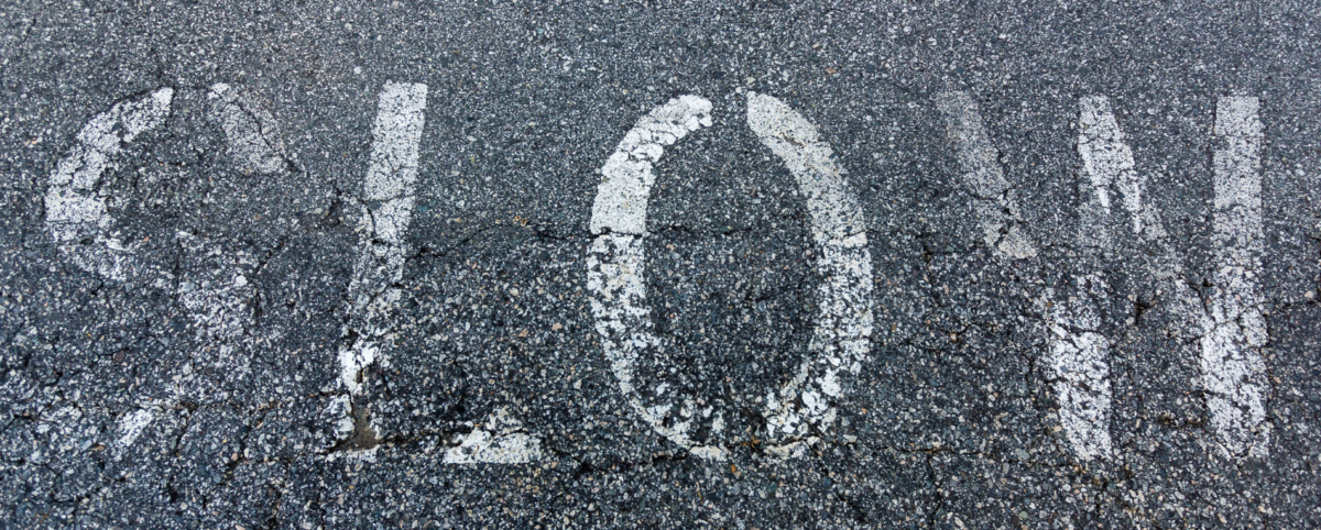 faded slow sign on pavement